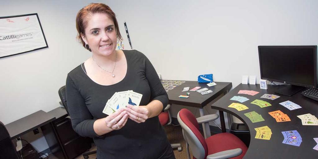 Catherine Swanwick holding set of cards.