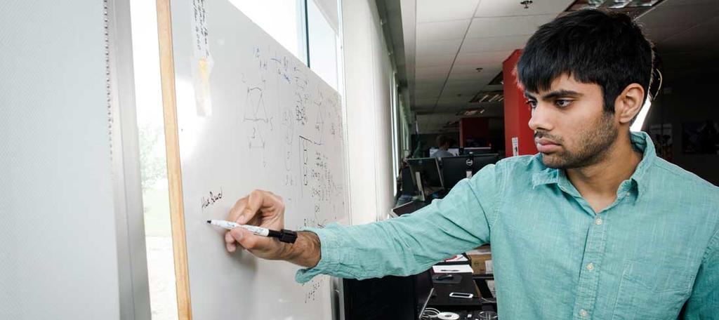 Rishub Nagpal working on a whiteboard